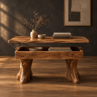 Lift top coffee table with a natural edge top and two trunk shaped legs in a dark studio against a charcoal plaster wall