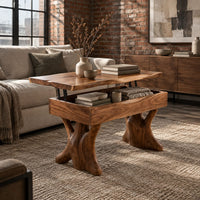 Lift top coffee table with a natural edge top and two trunk shaped legs in an industrial loft living room with exposed brick