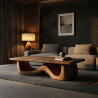 Light toned coffee table with a wave shaped base in a living room at golden hour