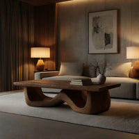 Light toned coffee table with a wave shaped base in an evening room lit by two lamps