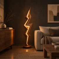 Lightning bolt floor lamp with angular faceted sides and a glowing seam in a dark living room at golden hour