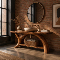 Live edge bathroom vanity on branching trunk legs with a low shelf in an industrial loft bathroom with exposed brick