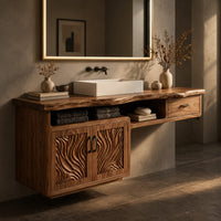 Corner detail of live edge bathroom vanity cabinet with carved wave doors and a small drawer beside wood, brass and linen samples