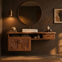 Live edge bathroom vanity cabinet with carved wave doors and a small drawer in a dark bathroom at golden hour