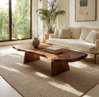 Live edge coffee table on two wedge pedestals in an open plan space in daylight