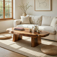 Thick live edge slab coffee table on block pedestals in a bright modern living room
