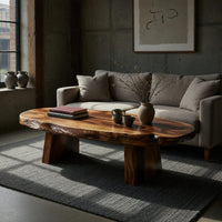 Thick live edge slab coffee table on block pedestals in a concrete and timber loft
