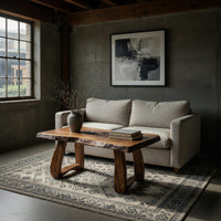 Live edge coffee table with a carved rosette inlay in a concrete and timber loft