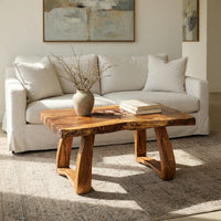 Live edge coffee table with a carved rosette inlay in an open plan space in daylight