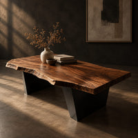 Live edge coffee table with a slab top and two angular wedge legs, three-quarter view showing the grain