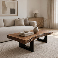 Live edge coffee table on two slab legs with arched cutouts in a Scandinavian living room with white walls
