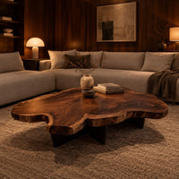 Live edge coffee table with a freeform slab top and dark angular base in an evening living room with walnut wall paneling