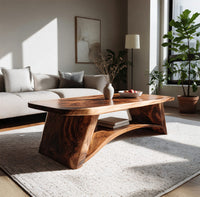 Live edge coffee table with sculpted legs and a low shelf in a sunlit room with large windows and plants