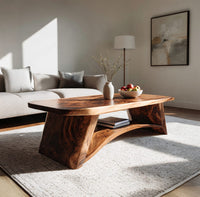 Live edge coffee table with sculpted legs and a low shelf in a bright modern living room