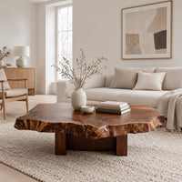 Live edge coffee table with a rugged slab top and block base in a Scandinavian living room with white walls