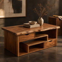 Corner detail of live edge coffee table with staggered open shelves and two small drawers beside wood, brass and linen samples
