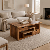 Live edge coffee table with staggered open shelves and two small drawers in a Scandinavian living room with white walls