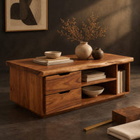 Corner detail of live edge coffee table with two drawers an open shelf and a side cubby beside wood, brass and linen samples