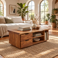 Live edge coffee table with two drawers an open shelf and a side cubby in a bright living room with arched windows and plants