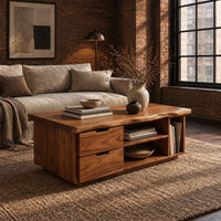 Live edge coffee table with two drawers an open shelf and a side cubby in an industrial loft living room with exposed brick