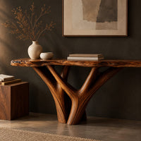 Corner detail of console table with a live edge slab top on a branching trunk base beside wood, brass and linen samples