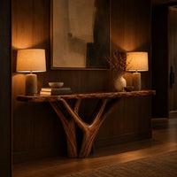Console table with a live edge slab top on a branching trunk base in an evening entryway with walnut wall paneling