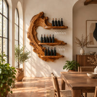 Live edge crescent wine rack with three shelves and rails for hanging stemware in a bright dining room with arched windows and plants