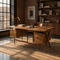 Live edge wooden desk with four drawers and slim tapered legs in an industrial loft home office with exposed brick