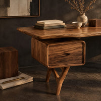Corner detail of live edge desk with drawer pods on forked legs beside wood, brass and linen samples