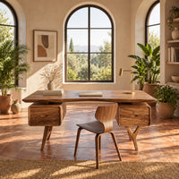 Live edge desk with drawer pods on forked legs in a bright home office with arched windows and plants