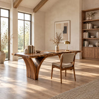 Live edge desk on two arched slab legs that flare toward the top in a bright open plan home office