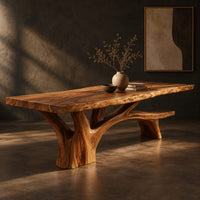 Live edge dining table on a branching tree trunk base, three-quarter view showing the grain