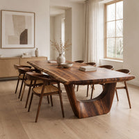 Live edge dining table on two sculpted arch pedestals in a Scandinavian dining room with white walls