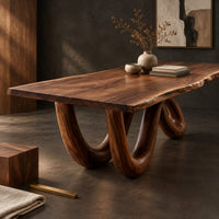 Corner detail of live edge dining table on two looping wave legs beside wood, brass and linen samples