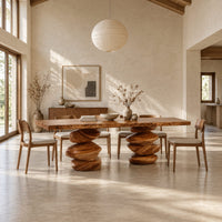 Live edge dining table with two stacked pebble shaped pedestal legs in a bright open plan dining room
