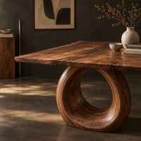 Corner detail of live edge dining table on a large open ring pedestal base beside wood, brass and linen samples