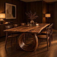 Live edge dining table on a large open ring pedestal base in an evening dining room with walnut wall paneling
