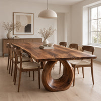 Live edge dining table on a large open ring pedestal base in a Scandinavian dining room with white walls