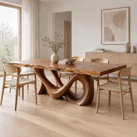 Live edge dining table with a looping figure eight base in a Scandinavian dining room with white walls