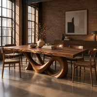 Live edge dining table with a looping figure eight base in an industrial loft dining room with exposed brick