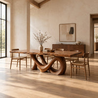 Live edge dining table with a looping figure eight base in a bright open plan dining room
