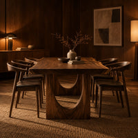 Live edge dining table with a slab top and arch cutout legs in an evening dining room with walnut wall paneling