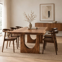 Live edge dining table with a slab top and arch cutout legs in a Scandinavian dining room with white walls