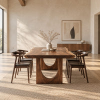 Live edge dining table with a slab top and arch cutout legs in a bright open plan dining room
