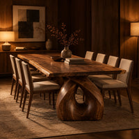 Live edge dining table on a single sculpted pedestal with a teardrop opening in an evening dining room with walnut wall paneling