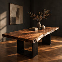 Live edge slab dining table on two open rectangular block legs, three-quarter view showing the grain