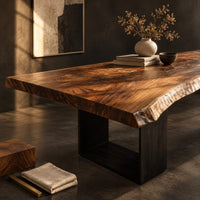 Corner detail of live edge slab dining table on two open rectangular block legs beside wood, brass and linen samples