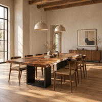 Live edge slab dining table on two open rectangular block legs in a bright open plan dining room