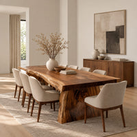 Live edge dining table with a thick slab top and tapered block base in a Scandinavian dining room with white walls