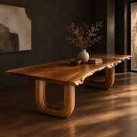 Live edge dining table on two thick u shaped legs, three-quarter view showing the grain